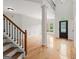 Bright foyer featuring gleaming hardwood floors, staircase, and a view of the second story landing at 7020 Grand View Way, Suwanee, GA 30024