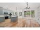 Open kitchen with gray cabinets, stainless steel appliances, hardwood floors, and eat-in area at 7020 Grand View Way, Suwanee, GA 30024