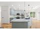 Updated kitchen with gray cabinets, stainless steel appliances, and marble countertops at 7020 Grand View Way, Suwanee, GA 30024