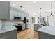 Modern kitchen featuring gray cabinets, stainless steel appliances, and hardwood floors at 7020 Grand View Way, Suwanee, GA 30024