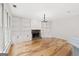 Open living room with hardwood floors, built-in shelving, fireplace and lots of light at 7020 Grand View Way, Suwanee, GA 30024