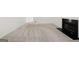 Open living room with neutral carpeting and a fireplace featuring a black marble hearth at 7020 Grand View Way, Suwanee, GA 30024