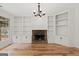 Living room with hardwood floors, stone fireplace and built-in shelving at 7020 Grand View Way, Suwanee, GA 30024