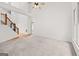 Open living room with high ceiling, large windows and staircase with wood trim at 7020 Grand View Way, Suwanee, GA 30024