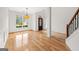 Open-concept living room with hardwood floors, large windows, and elegant trim at 7020 Grand View Way, Suwanee, GA 30024
