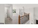 A carpeted open loft space features a window, railing, and natural light at 7020 Grand View Way, Suwanee, GA 30024