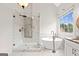 Bright main bathroom featuring a glass-enclosed shower, soaking tub, and stylish fixtures at 7020 Grand View Way, Suwanee, GA 30024