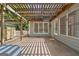 Covered patio area featuring a wooden pergola and access to the backyard at 7020 Grand View Way, Suwanee, GA 30024