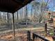 View of wooded backyard with trampoline from covered back porch at 177 Villa Rosa Way, Temple, GA 30179