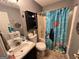 Functional bathroom with a shower-tub combination, single sink vanity, and a bright shower curtain at 177 Villa Rosa Way, Temple, GA 30179