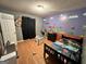 Fun bedroom with custom painted walls, a single bed, and laminate flooring at 177 Villa Rosa Way, Temple, GA 30179