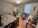 Comfortable bedroom with a patterned bedspread, laminate flooring, and a bright window at 177 Villa Rosa Way, Temple, GA 30179
