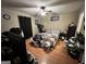 Bedroom with unmade bed, ceiling fan, wood laminate flooring and dark curtains at 177 Villa Rosa Way, Temple, GA 30179