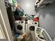 Laundry room with dual white washing machines and wire shelving stocked with laundry supplies at 177 Villa Rosa Way, Temple, GA 30179