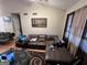 Spacious living room with hardwood floors, a large leather sofa, and a modern area rug at 177 Villa Rosa Way, Temple, GA 30179