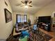 Inviting living room with a large sectional sofa, media center, and a ceiling fan for added comfort at 177 Villa Rosa Way, Temple, GA 30179