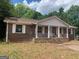 Charming brick ranch-style home featuring a cozy front porch and well-maintained landscaping at 13090 Brown Bridge Rd, Covington, GA 30016