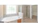 Bathroom featuring soaking tub, separate glass shower, and tile flooring at 3183 Jackson Creek Dr, Stockbridge, GA 30281