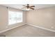 Comfortable bedroom featuring a ceiling fan, large window, and neutral walls at 3183 Jackson Creek Dr, Stockbridge, GA 30281