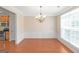 Formal dining room with hardwood floors, elegant chandelier, and large window for natural light at 3183 Jackson Creek Dr, Stockbridge, GA 30281