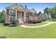 Beautiful brick home with lush green lawn and mature trees in a quiet neighborhood at 3183 Jackson Creek Dr, Stockbridge, GA 30281