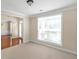 Cozy living room with neutral carpet, a large window, and elegant molding at 3183 Jackson Creek Dr, Stockbridge, GA 30281