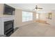 Spacious living room with fireplace, ceiling fan and adjacent dining area at 3183 Jackson Creek Dr, Stockbridge, GA 30281