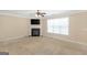 Cozy living room featuring a fireplace, ceiling fan, and a large window at 3183 Jackson Creek Dr, Stockbridge, GA 30281