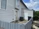 Back exterior of the home featuring gray siding, patio, and white doors at 237 Country Club Dr, Jonesboro, GA 30238