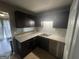 Updated kitchen featuring tile flooring, updated countertops, and dark cabinetry at 237 Country Club Dr, Jonesboro, GA 30238