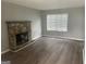 Bright living room featuring a stone fireplace and hardwood flooring at 237 Country Club Dr, Jonesboro, GA 30238