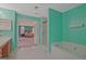 The spacious bathroom features a soaking tub and a doorway leading into the main bedroom at 6697 Princeton Park Walk, Lithonia, GA 30058