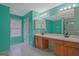 Bright bathroom featuring a double vanity, white tile floors, and large mirror reflecting the shower area at 6697 Princeton Park Walk, Lithonia, GA 30058