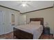 Bedroom with a bed, two nightstands, and wood flooring at 6697 Princeton Park Walk, Lithonia, GA 30058