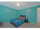 Bright bedroom with a blue-themed decor and a bed featuring superhero bedding at 6697 Princeton Park Walk, Lithonia, GA 30058