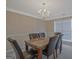 Elegant dining room featuring a marble-top table, leather chairs, and a chandelier at 6697 Princeton Park Walk, Lithonia, GA 30058