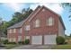 Charming two-story brick home featuring a two-car garage and well-maintained landscaping at 6697 Princeton Park Walk, Lithonia, GA 30058