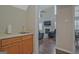 Wet bar off hallway with view of living area with fireplace, TV, and black recliners at 6697 Princeton Park Walk, Lithonia, GA 30058