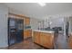 The kitchen has wood cabinets, an island, and appliances including a black refrigerator at 6697 Princeton Park Walk, Lithonia, GA 30058
