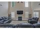 Spacious living room featuring a fireplace, high ceilings, and comfortable leather furniture at 6697 Princeton Park Walk, Lithonia, GA 30058