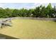 Large, well-maintained backyard with green grass, wooden fence and play set, great for outdoor activities at 8045 Coleson Xing, Locust Grove, GA 30248