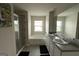 Bathroom featuring double sinks, bathtub, walk-in shower, and neutral wall paint at 8045 Coleson Xing, Locust Grove, GA 30248