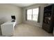 A bright bedroom with a desk, shelves and a large window letting in plenty of light at 8045 Coleson Xing, Locust Grove, GA 30248