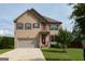 Charming two-story home with attached two-car garage and well-maintained front lawn and tasteful shutters at 8045 Coleson Xing, Locust Grove, GA 30248