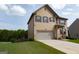 Two-story home featuring a spacious two-car garage and a beautifully maintained lawn at 8045 Coleson Xing, Locust Grove, GA 30248