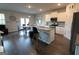 Open-concept kitchen and dining area featuring modern white cabinets and stainless steel appliances and an island at 8045 Coleson Xing, Locust Grove, GA 30248
