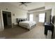 Bright main bedroom features tray ceilings, plush carpet, a king bed, and ensuite bathroom at 8045 Coleson Xing, Locust Grove, GA 30248