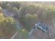An aerial view showing a home with a yard and driveway in a wooded neighborhood at 323 Nicole Dr, Temple, GA 30179