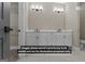 Bathroom featuring a dual sink vanity with white cabinets, black hardware, and tile flooring at 323 Nicole Dr, Temple, GA 30179