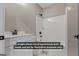 Bathroom featuring white vanity, tub/shower combination and stylish black fixtures at 323 Nicole Dr, Temple, GA 30179